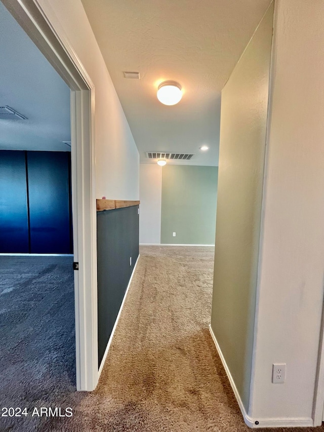 hallway with carpet flooring