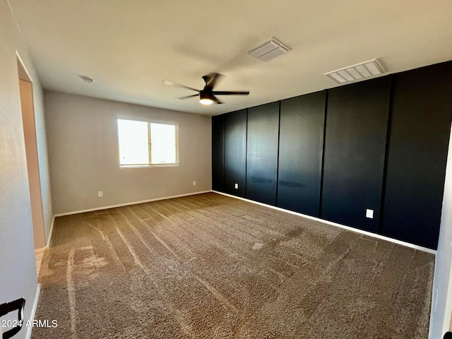 unfurnished bedroom with ceiling fan and carpet