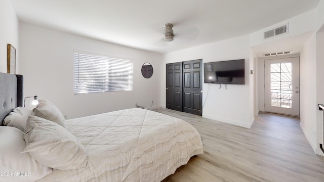 bedroom with a closet, ceiling fan, and light wood-type flooring