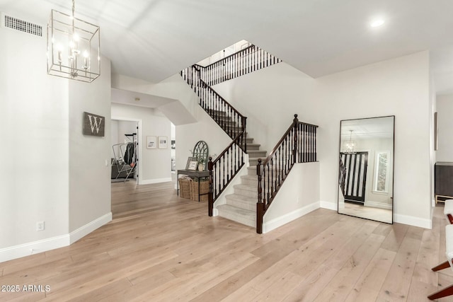 foyer featuring a chandelier and light wood-type flooring