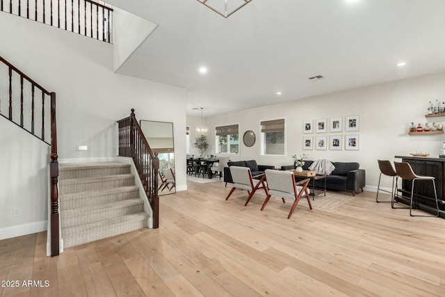 dining room featuring indoor bar and light hardwood / wood-style floors