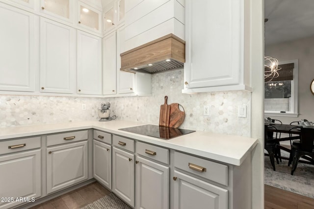 kitchen featuring tasteful backsplash, black electric stovetop, and gray cabinetry