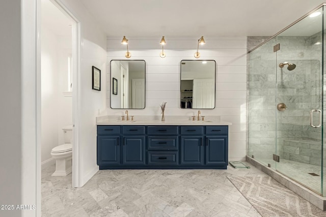 bathroom featuring vanity, an enclosed shower, and toilet