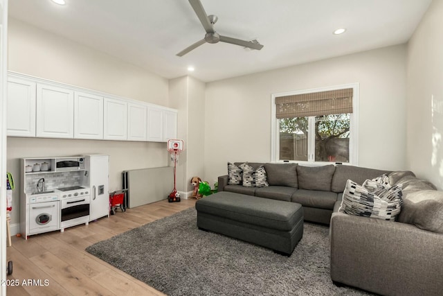 living room featuring ceiling fan and light wood-type flooring