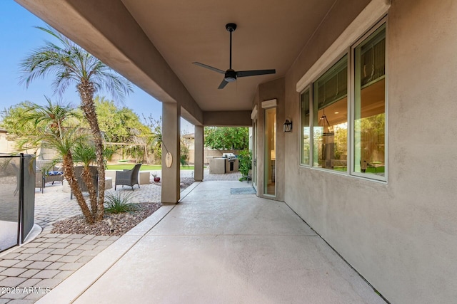 view of patio with ceiling fan and an outdoor kitchen