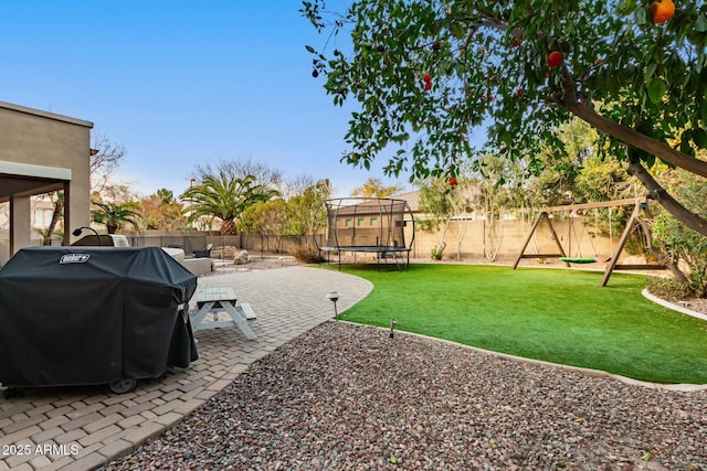 view of yard with a playground, a trampoline, and a patio area