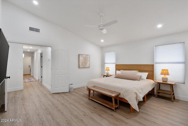 bedroom with light hardwood / wood-style flooring, ceiling fan, and lofted ceiling