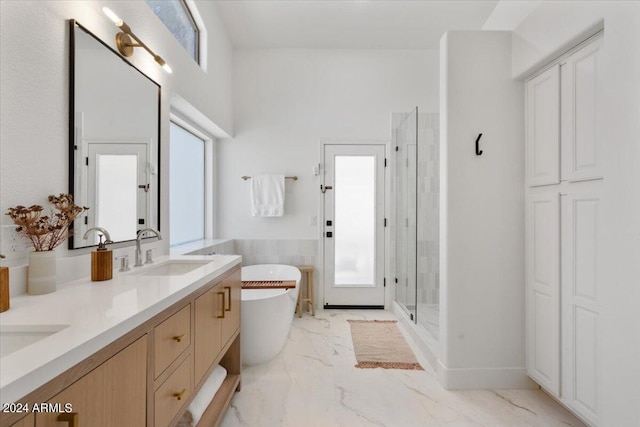 bathroom featuring vanity and shower with separate bathtub