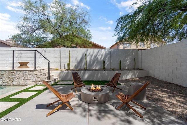 view of patio / terrace with an outdoor fire pit