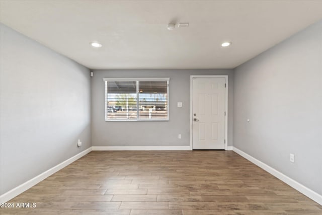 spare room featuring wood-type flooring