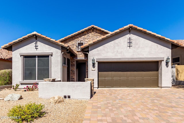view of front of property featuring decorative driveway, stucco siding, and a garage