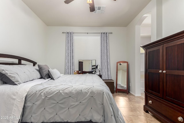 bedroom featuring light tile patterned flooring, baseboards, visible vents, and ceiling fan