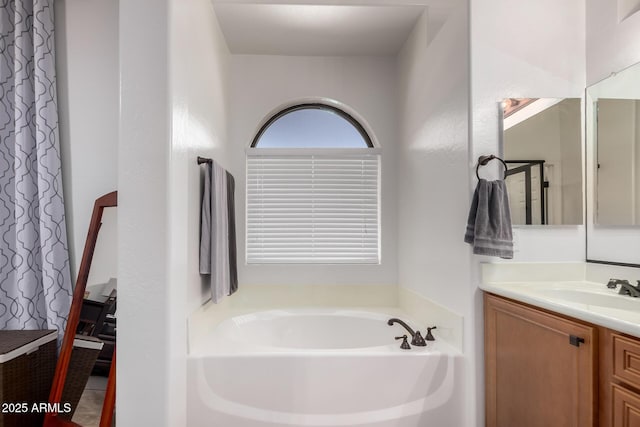 full bath with vanity and a garden tub