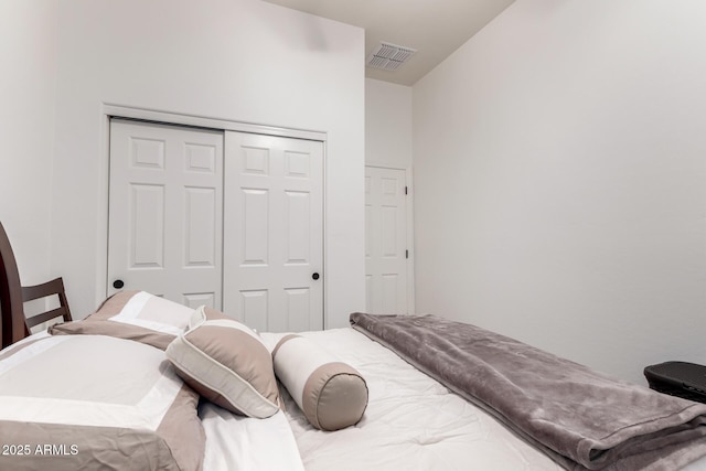 bedroom with visible vents and a closet