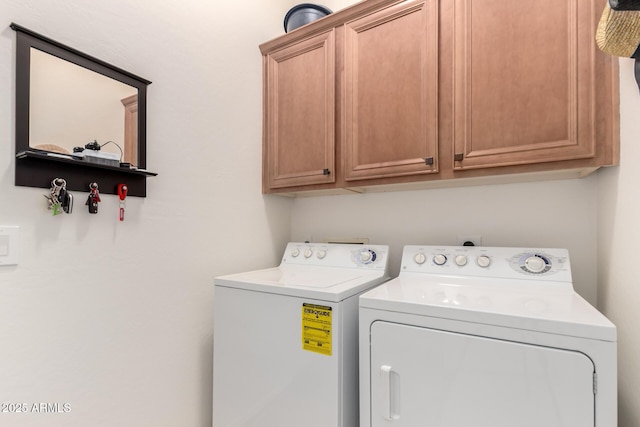 laundry room featuring washer and clothes dryer and cabinet space
