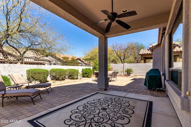 view of patio / terrace with a fenced backyard, grilling area, ceiling fan, and outdoor dining space