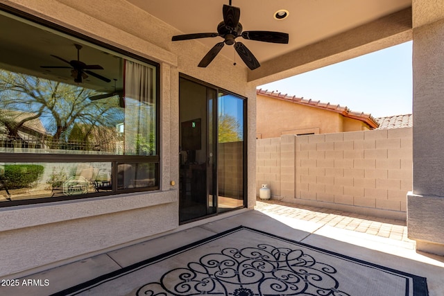 view of patio / terrace with ceiling fan and fence