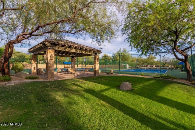 surrounding community with a yard, a tennis court, a gazebo, and fence