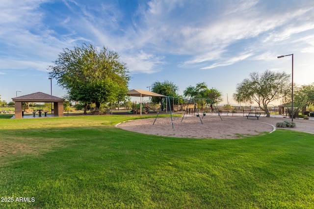 view of property's community with a gazebo, playground community, and a yard