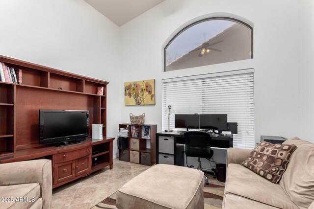 office with a towering ceiling and a ceiling fan