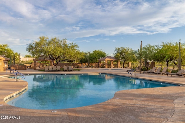 community pool featuring a gazebo, fence, and a patio