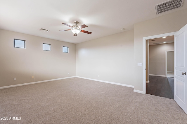 carpeted spare room with ceiling fan