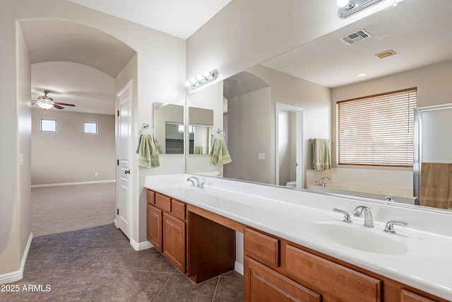 bathroom with ceiling fan, a washtub, tile patterned flooring, toilet, and vanity