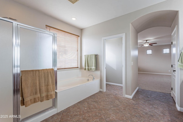 bathroom with shower with separate bathtub, a wealth of natural light, and ceiling fan