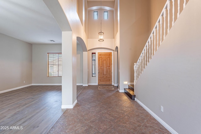 foyer entrance with a towering ceiling