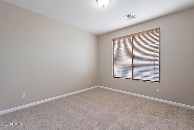 carpeted spare room featuring a wealth of natural light