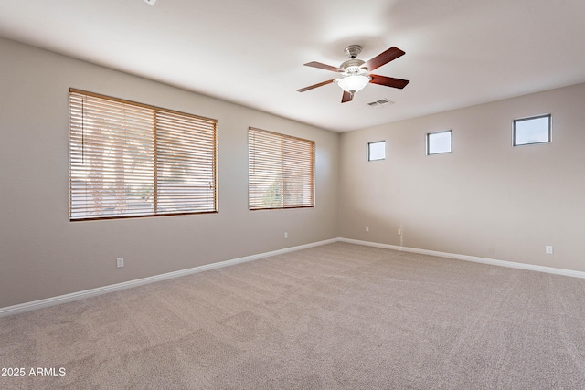 spare room featuring ceiling fan and light colored carpet