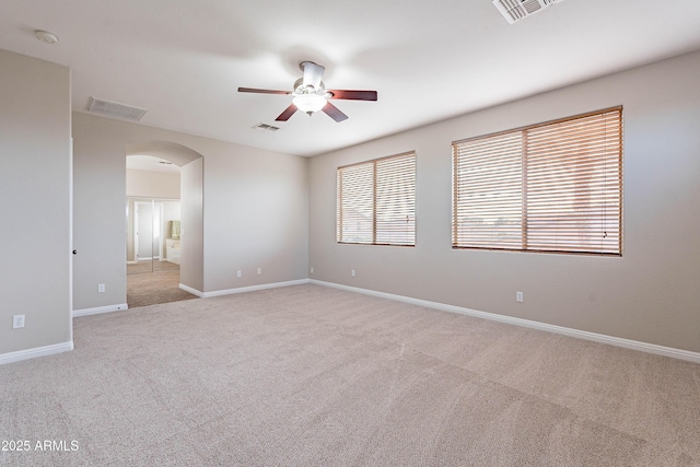 carpeted spare room with ceiling fan