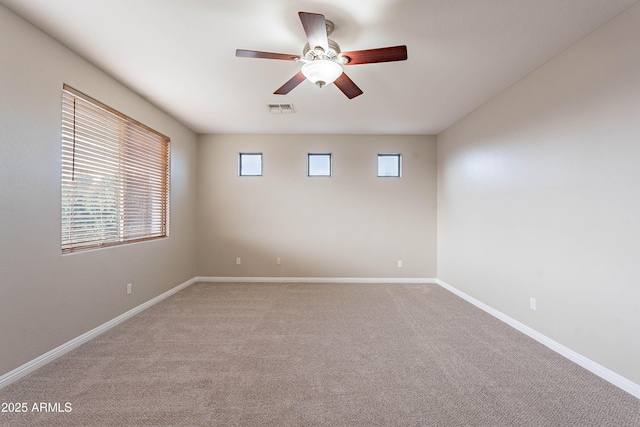 empty room featuring carpet flooring and ceiling fan