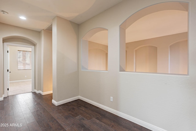 spare room featuring dark wood-type flooring