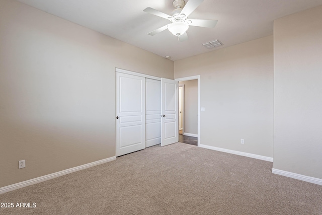 unfurnished bedroom with ceiling fan, a closet, and carpet floors