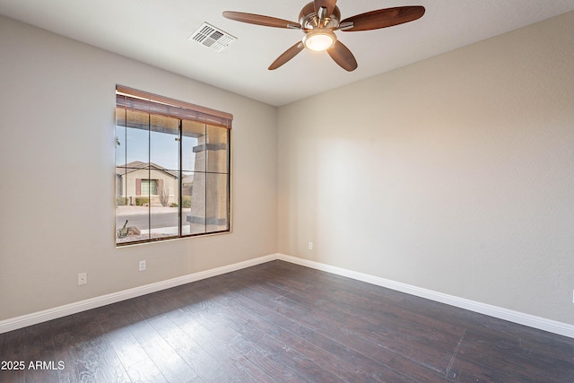 empty room with ceiling fan and dark hardwood / wood-style flooring