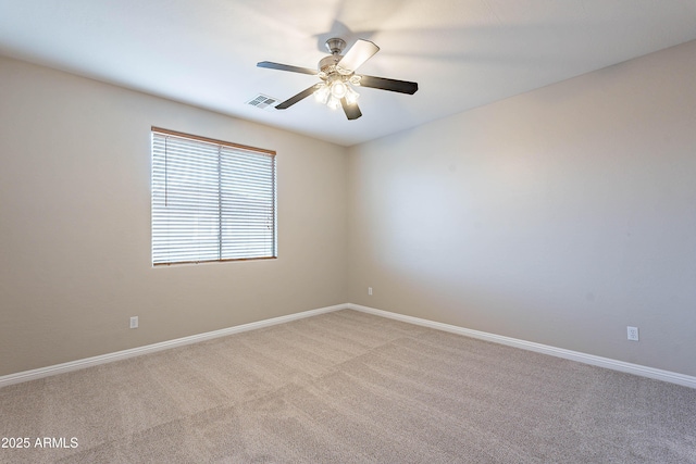 carpeted spare room featuring ceiling fan