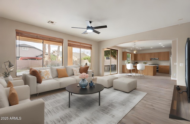 living room featuring light hardwood / wood-style floors and ceiling fan