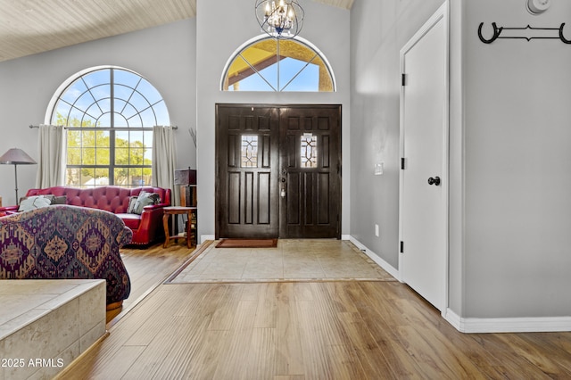 6249 E Camelot Dr, Mesa, AZ 85215 - entryway with wood finished floors, high vaulted ceiling, and a chandelier