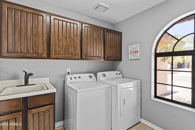 6249 E Camelot Dr, Mesa, AZ 85215 - washroom featuring cabinet space, washing machine and dryer, and a textured ceiling