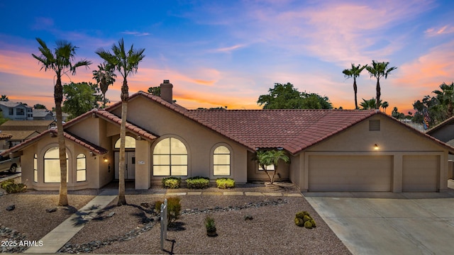 6249 E Camelot Dr, Mesa, AZ 85215 - view of front of house with a garage, concrete driveway, stucco siding, a chimney, and a tile roof