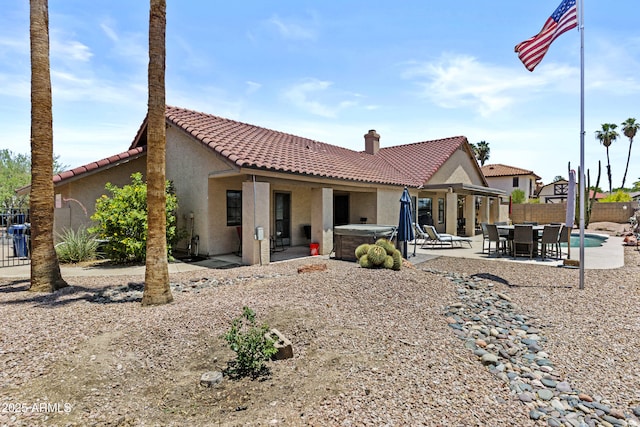 6249 E Camelot Dr, Mesa, AZ 85215 - rear view of house with a hot tub, a fenced backyard, stucco siding, a tile roof, and a patio area