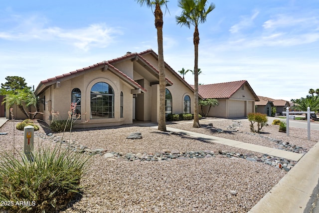 6249 E Camelot Dr, Mesa, AZ 85215 - mediterranean / spanish-style house featuring stucco siding, concrete driveway, a tiled roof, and an attached garage
