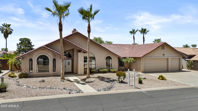 6249 E Camelot Dr, Mesa, AZ 85215 - mediterranean / spanish house featuring stucco siding, an attached garage, concrete driveway, and a tile roof