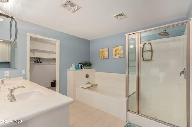 bathroom featuring a bath, visible vents, a shower stall, and tile patterned flooring