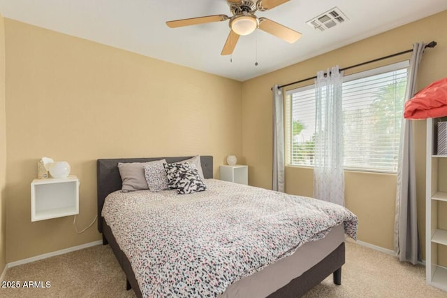 bedroom featuring a ceiling fan, baseboards, visible vents, and light carpet