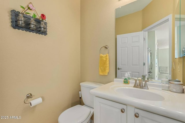 bathroom featuring toilet and vanity