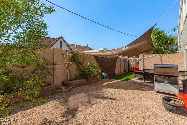 view of yard featuring a fenced backyard and a patio