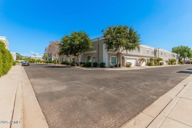 view of road featuring a residential view, curbs, and sidewalks