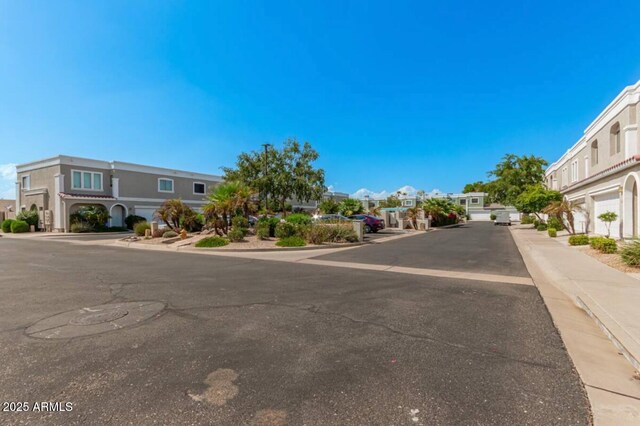 view of road with sidewalks and a residential view